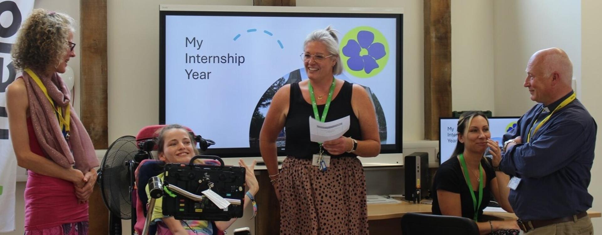Supported Internship lead Hazel giving a presentation with intern and their employer about their internship programme