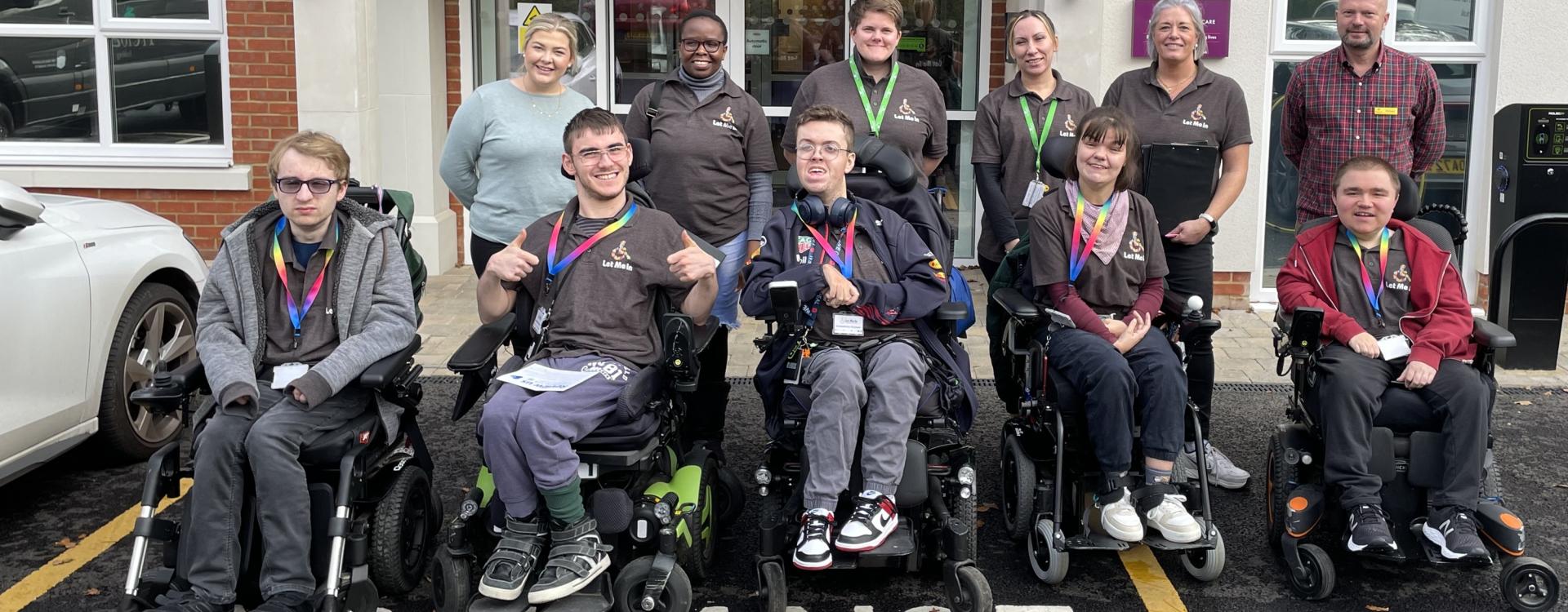 Group of Treloar College students all wearing Let Me In T-shirts outside Hamberley Neurocare in Camberley