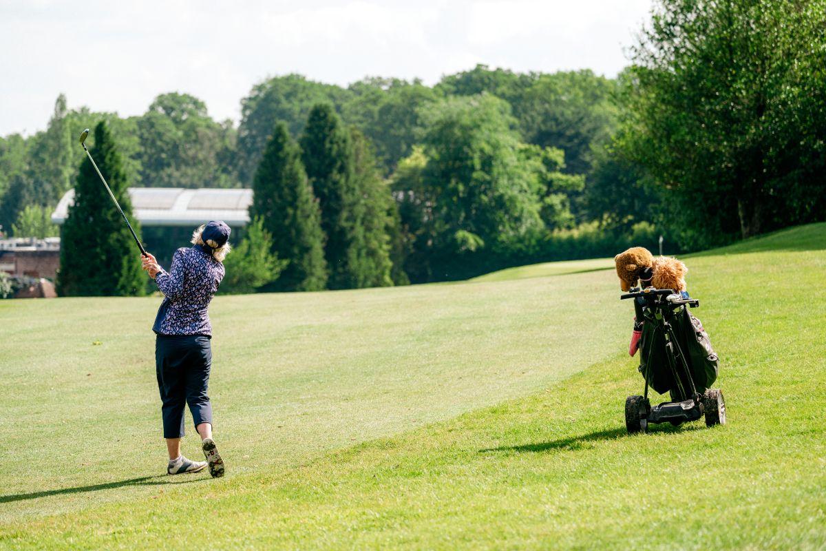 Lady playing golf at The Old Thorns Hotel & Resort