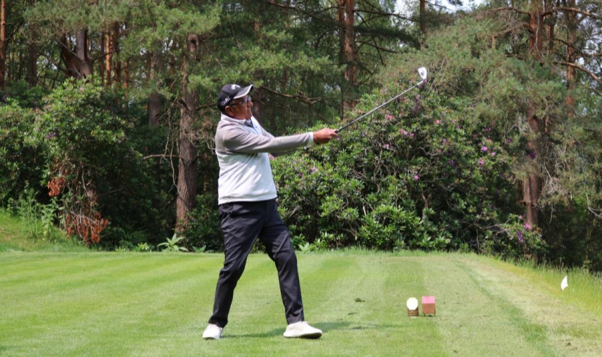 Action shot of a golfer on the green at Old Thorns Liphook