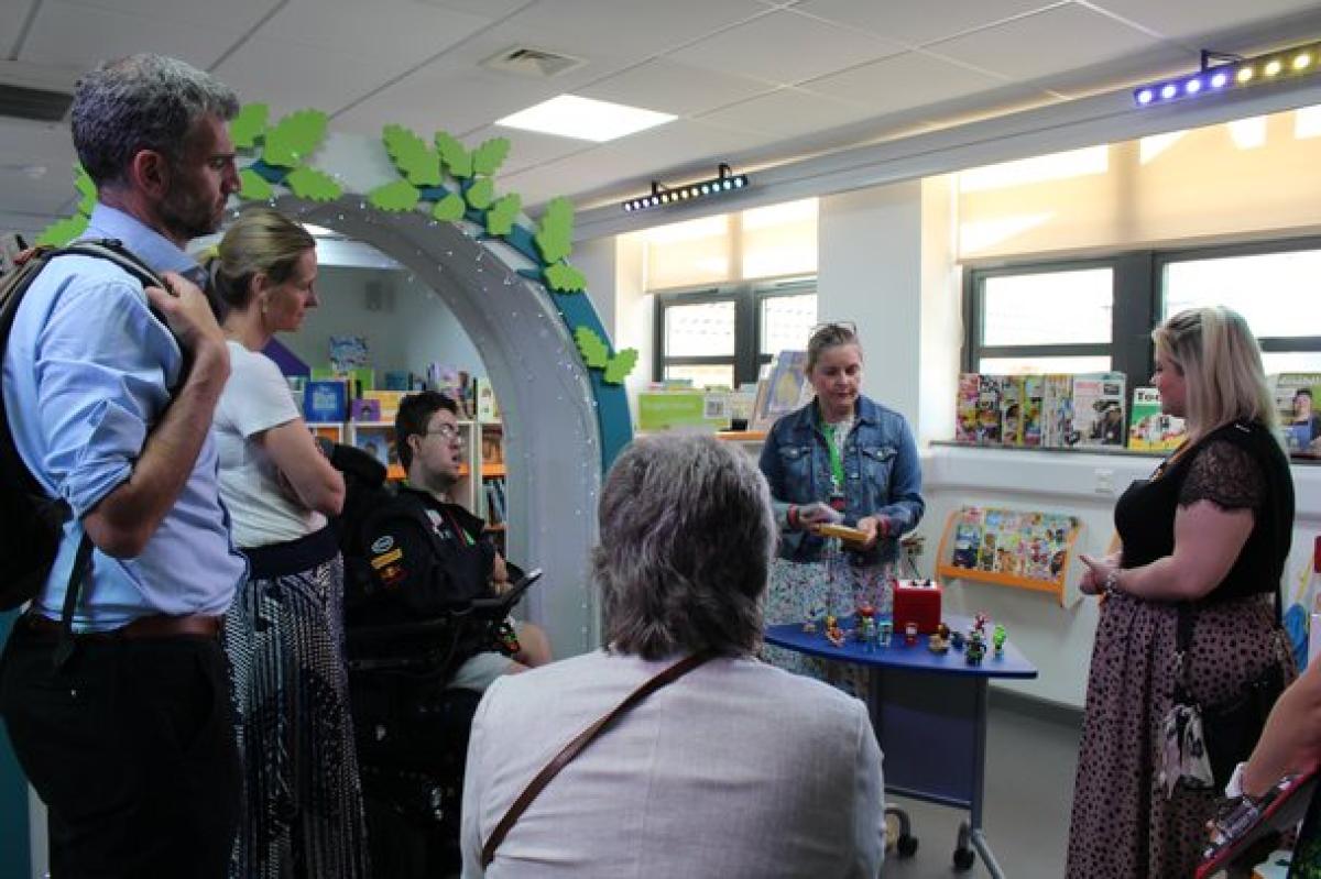 Donors at the official opening of the new Bradbury Learning Centre; all gathered around in the library, listening to a talk.