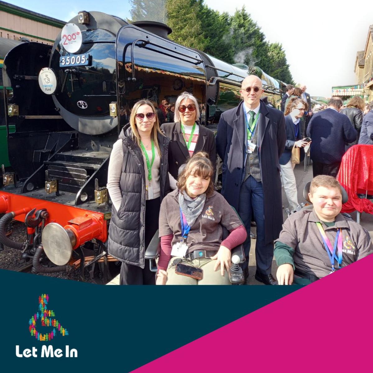 Let Me In team pose in front of The Canadian Pacific steam train at The Watercress Line