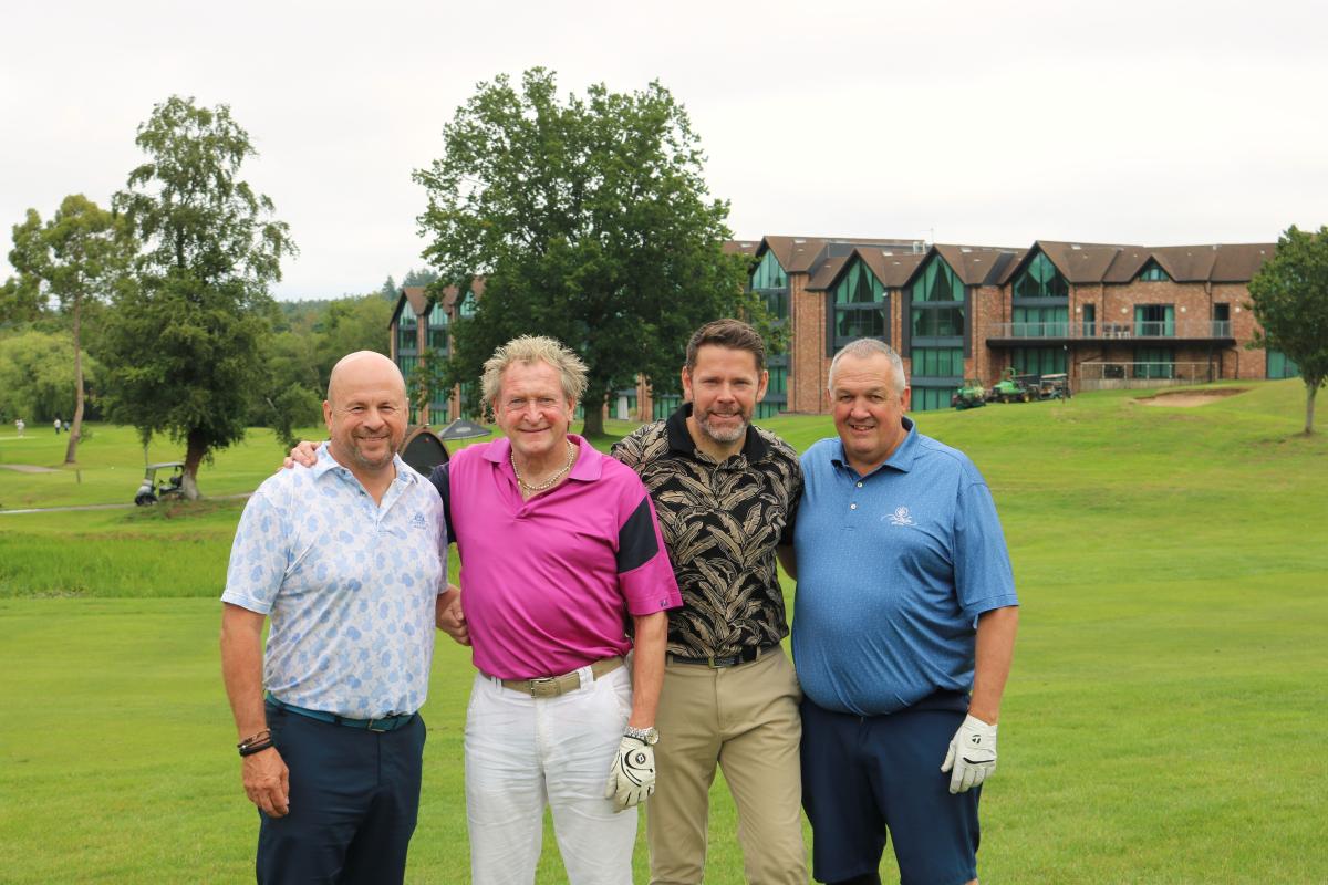 Golfers on course, stood in front of Old Thorns