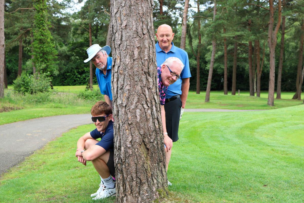 Golfers on the golf course, hiding behind a tree