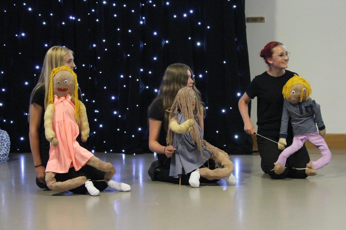Students perform using puppets at Treloar's Art Exchange