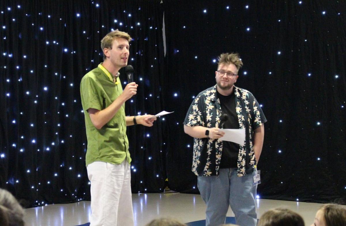 Luke and Elliott perform at Treloar's Art Exchange, in front of a starry black curtain