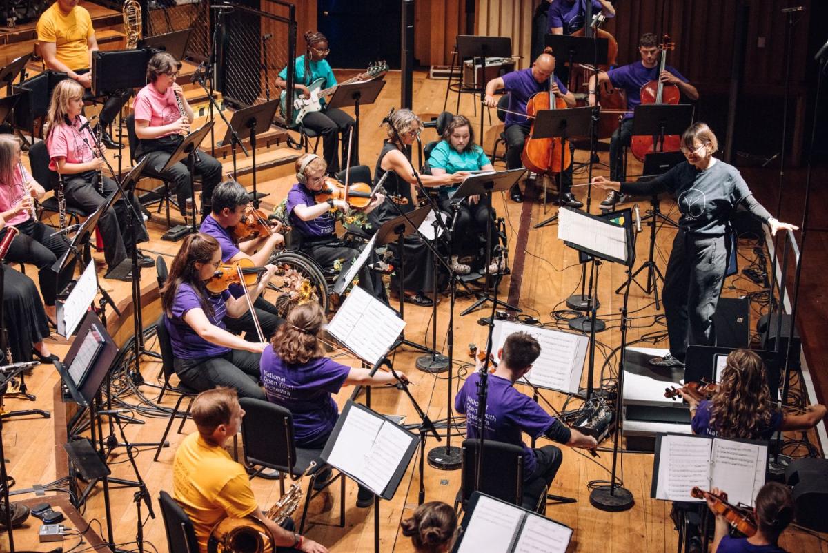 National Open Youth Orchestra musicians on a stage.