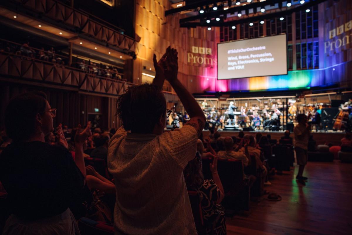 Audience members on their feet applauding the National Open Youth Orchestra performance at Bristol Beacon.