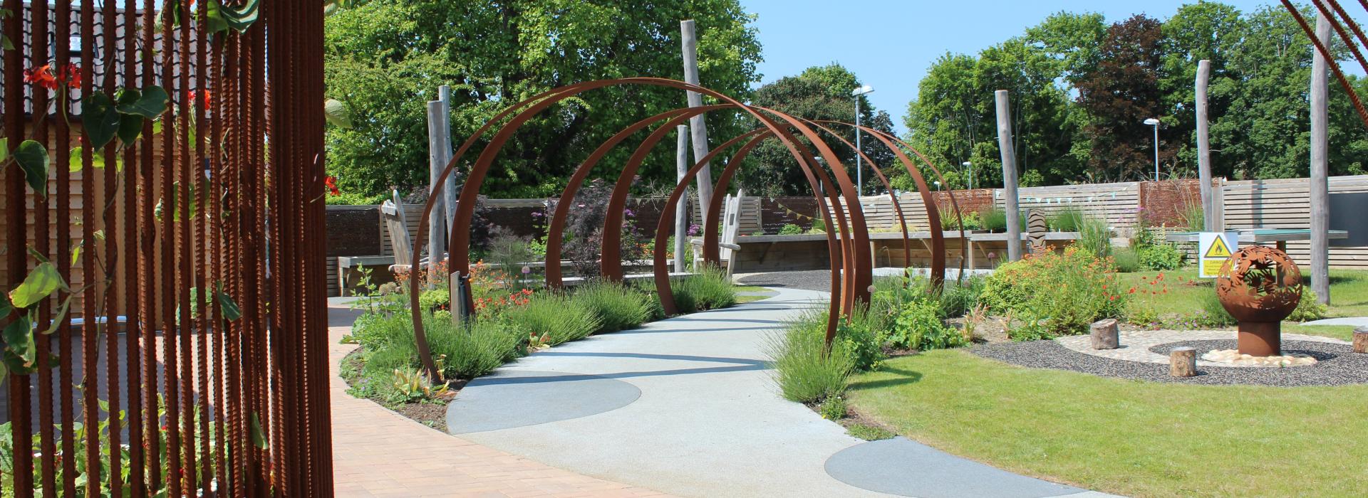 Treloar's Outdoor Learning Centre sensory garden, seen through the archway with fire pit feature