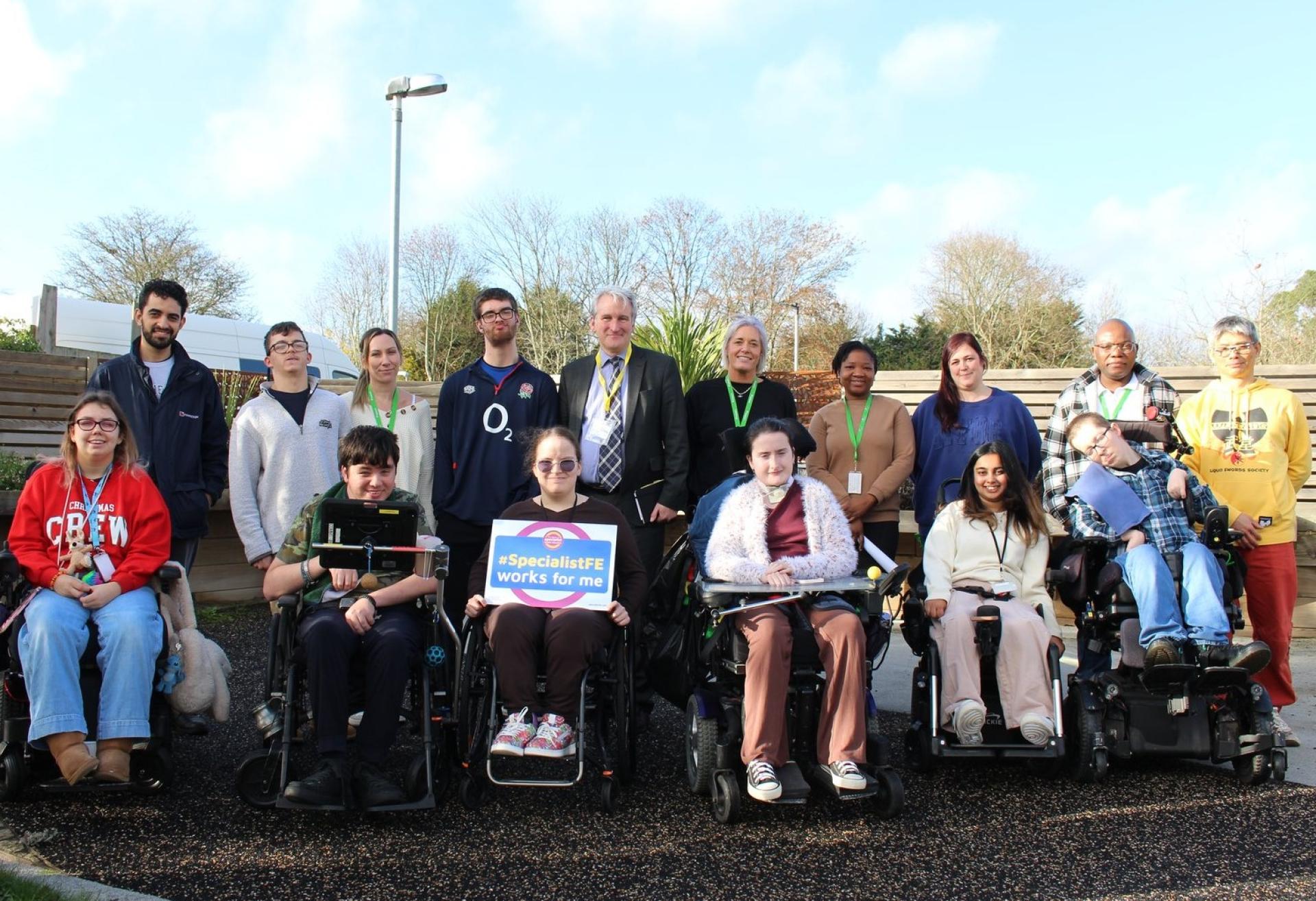 Damian Hinds, MP for East Hampshire with a group of Treloar College students, one is holding a pledge board which says 'Specialist FE works for me'