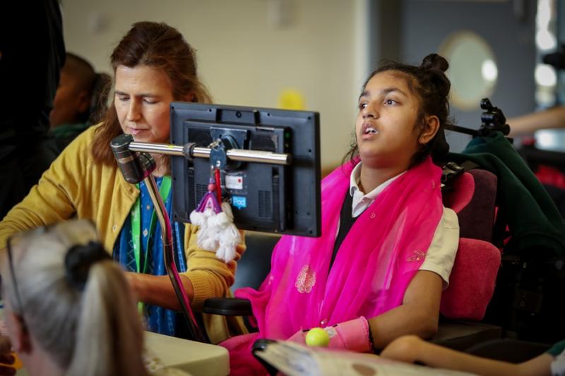 Treloar's student in the classroom, her assistant sat next to her.