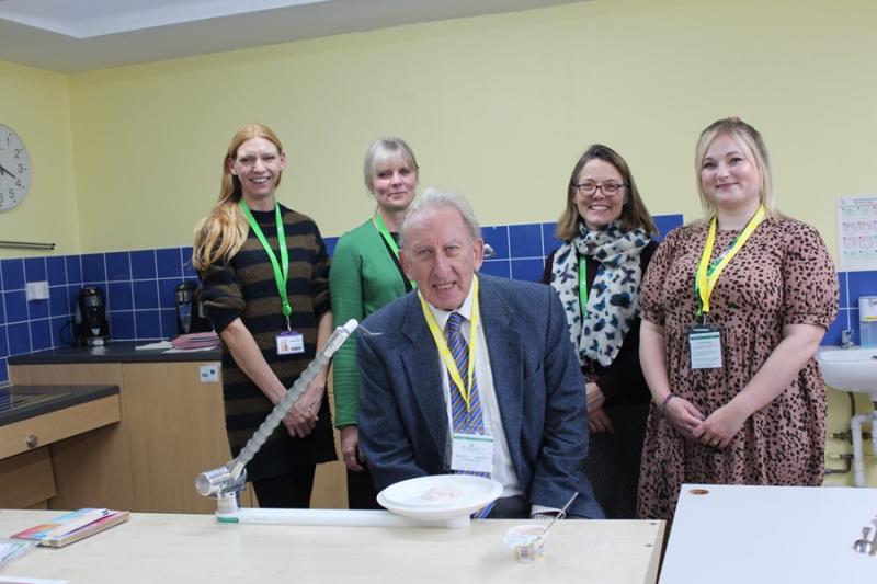 Louise Spicer, Senior Occupational Therapist, Vicky Pitt, Head of Occupational Therapy and Karen Dawson, Head of Trusts, of Treloar's with Cllr Graham Hill with the Neater Eater his grant helped pay for