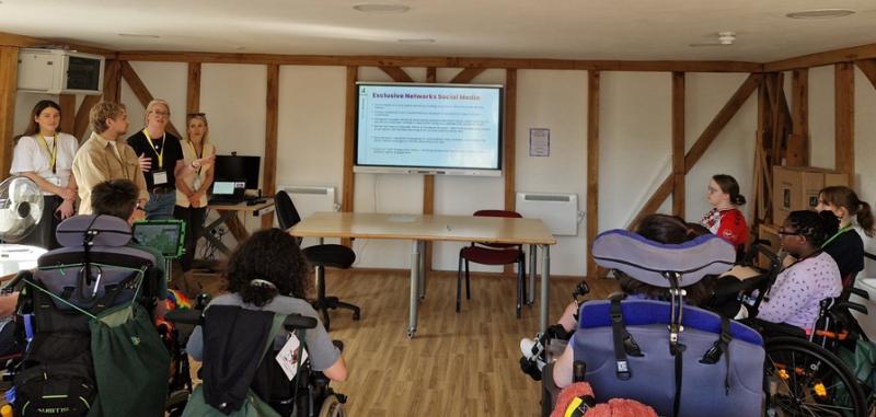 Members of the Exclusive Networks marketing team delivering a social media workshop for Treloar's students in a classroom