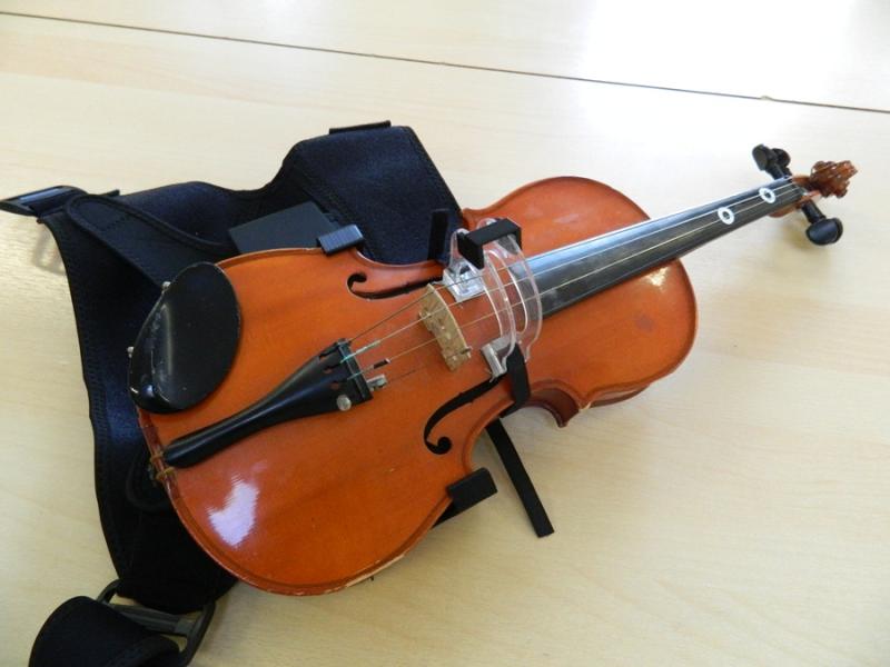 A violin with a black strap.