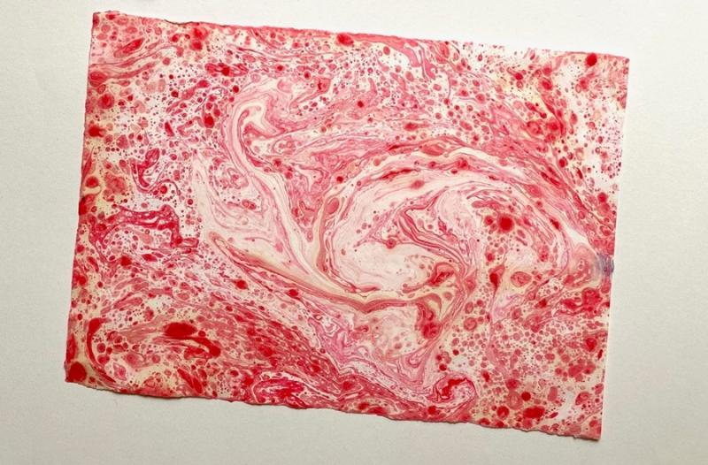 An example of paper marbling art in red.