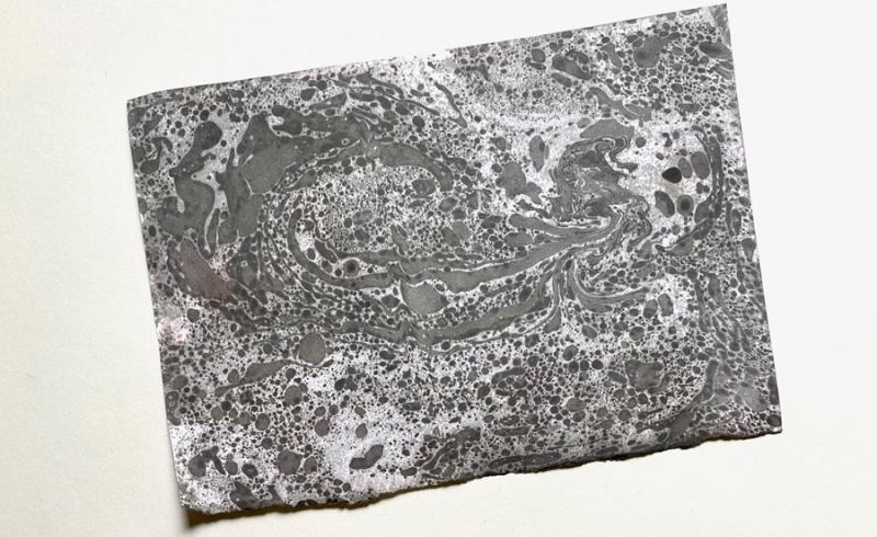 An example of paper marbling art in black.
