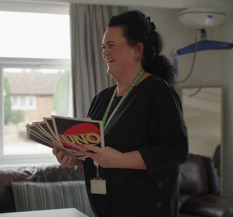 Deputy team leader Sarah holding over sized UNO cards
