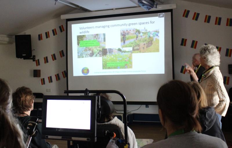 Treloar's students attending a presentation on bug hotels, with slides projected on a screen.
