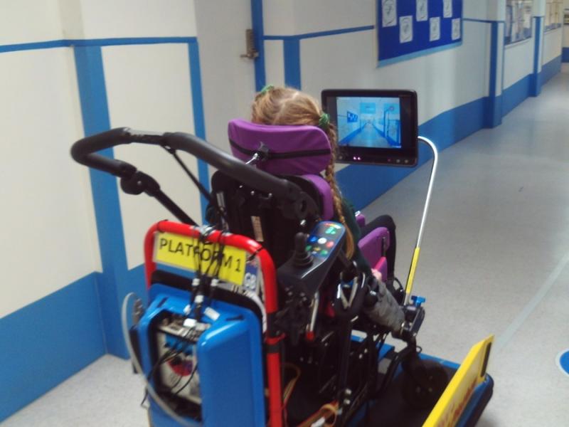 Treloar's student during on-site driving sessions using the Ability Drive system: her wheelchair is placed on a SMART Platform and she is using her eyes to drive it.