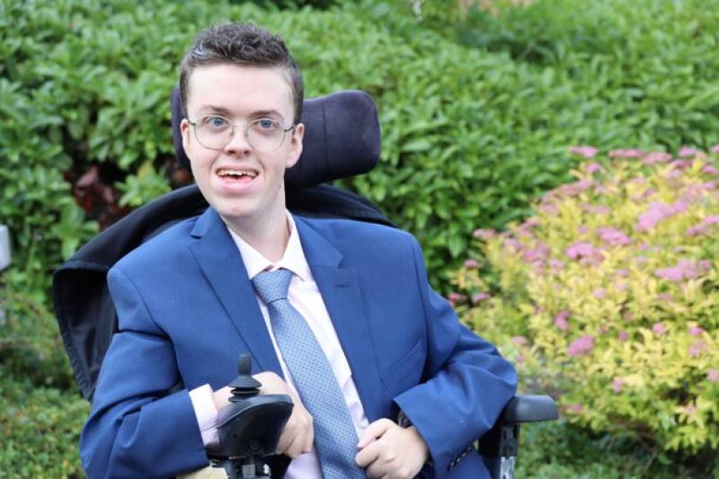 Treloar College student dressed in a blue suit and tie at prom