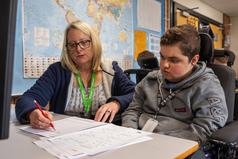 Treloar College student working at HSDC Alton College with support assistant alongside