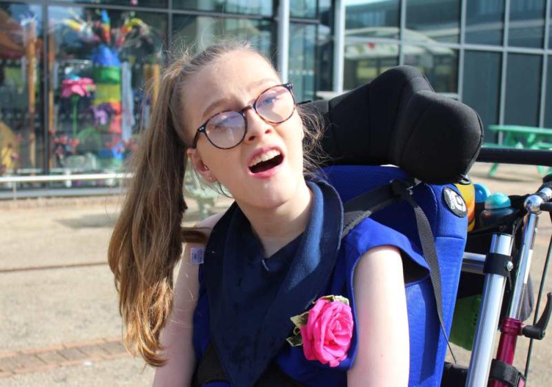 College prom, student wearing a blue dress and a pink rose corsage