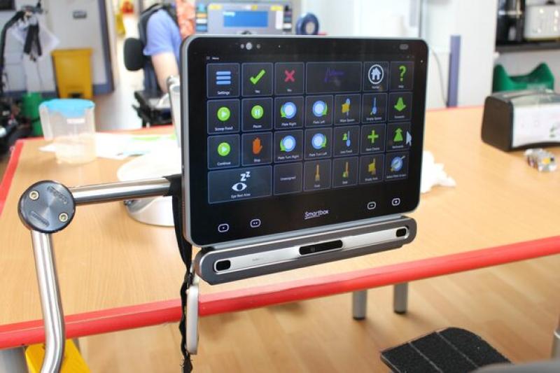 Augmentative and Alternative communication device mounted on a frame, set up to work with eye-gaze