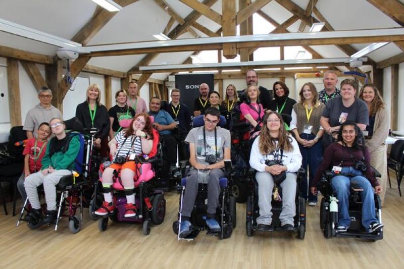 A group of College students in wheelchairs with cameras attending a Sony photography workshop