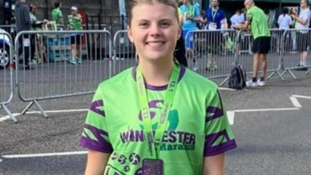 Lauren after finishing the Winchester Half-Marathon - wearing a green T-shirt.