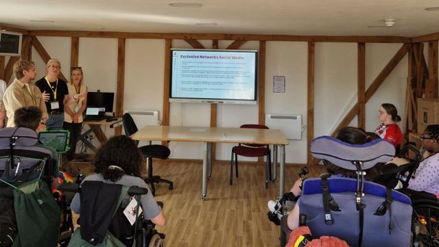Members of the Exclusive Networks marketing team delivering a social media workshop for Treloar's students in a classroom