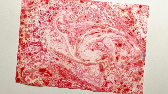 An example of paper marbling art in red.