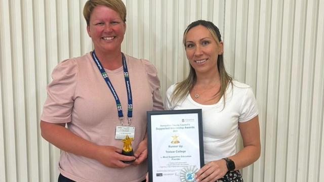 Holly Larvan, Treloar's Supported Internship Technician and Gemma Foreman from Southampton Airport posing for a photo with an award and a certificate.