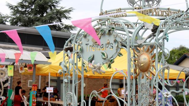 Treloar's archway and a colourful bunting across of it.