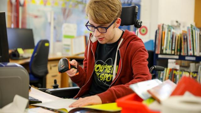 Treloar College student doing work experience in the library