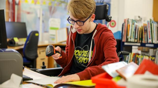 Treloar College student doing work experience in the library