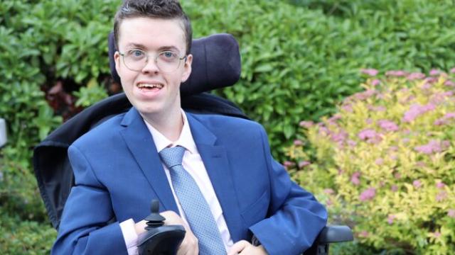 Treloar College student dressed in a blue suit and tie at prom
