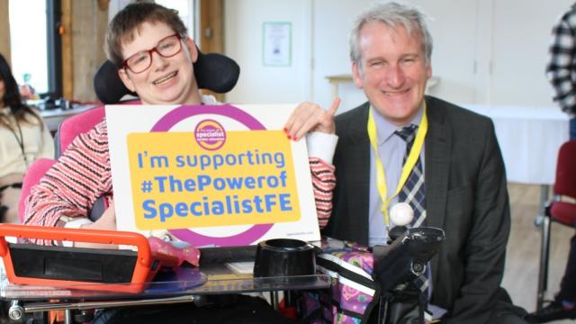 Treloar College student with Damian Hinds MP holding pledge board which says 'I'm supporting the Power of Specialist FE'
