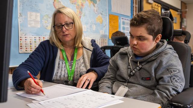 Treloar College student working at HSDC Alton College with support assistant alongside