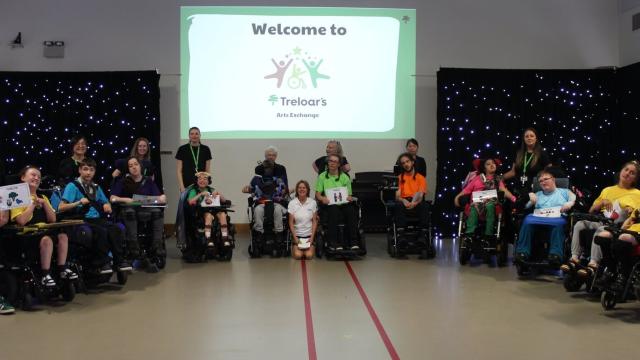 A group of students in wheelchairs, seated in a semi circle, at Treloar's Art Exchange June 2026