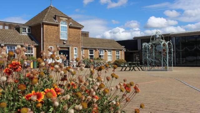 Treloar College Piazza looking towards the Blacksmith's archway, with orange flowers in foreground