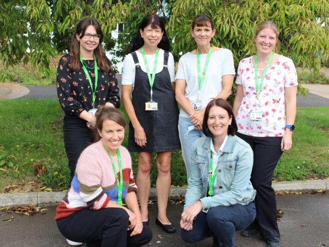 A group photo of Treloar's Counselling Team taken outdoors: a green lawn and a tree behind the team.
