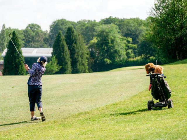 Lady playing golf at The Old Thorns Hotel & Resort