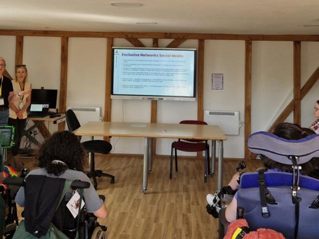 Members of the Exclusive Networks marketing team delivering a social media workshop for Treloar's students in a classroom