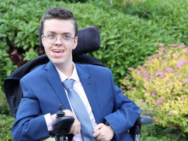 Treloar College student dressed in a blue suit and tie at prom