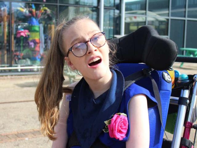 College prom, student wearing a blue dress and a pink rose corsage