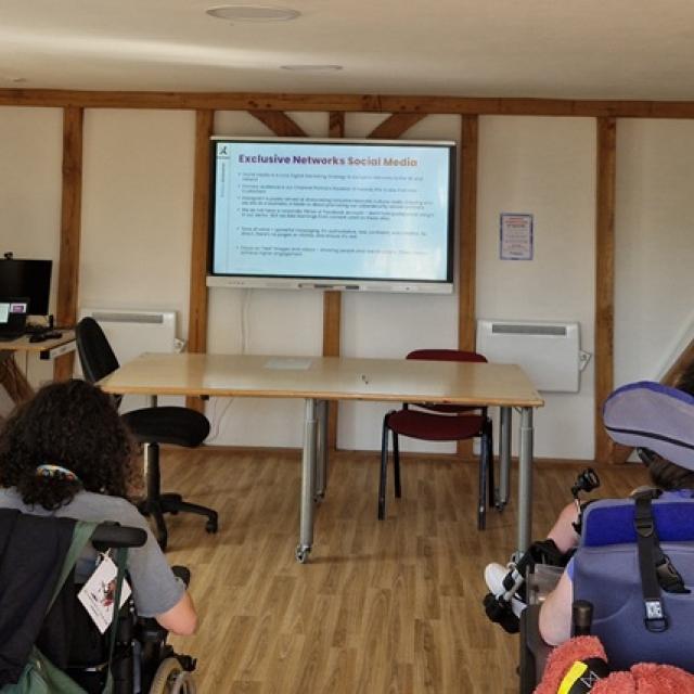 Members of the Exclusive Networks marketing team delivering a social media workshop for Treloar's students in a classroom