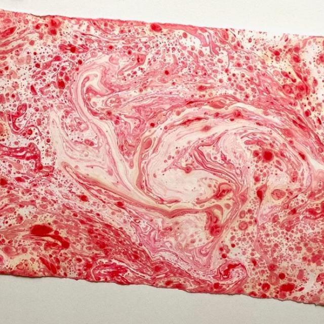 An example of paper marbling art in red.