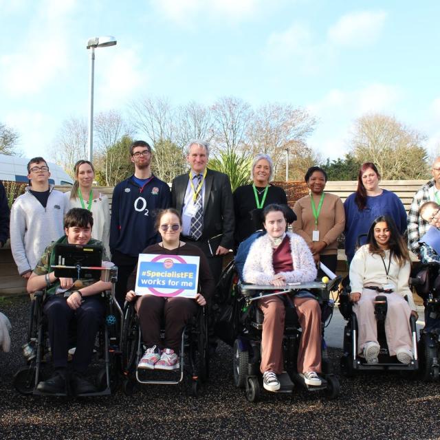 Damian Hinds, MP for East Hampshire with a group of Treloar College students, one is holding a pledge board which says 'Specialist FE works for me'