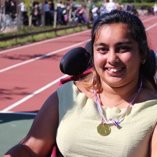 Student wearing a Sports Day medal on the race track