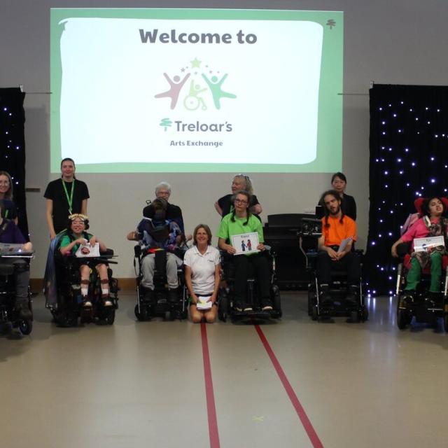 A group of students in wheelchairs, seated in a semi circle, at Treloar's Art Exchange June 2026